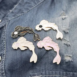 Cute koi fish enamel pins in black white and pink set on denim fabric background