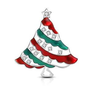Detailed view of silver Christmas tree brooch with red green enamel and zircon stones
