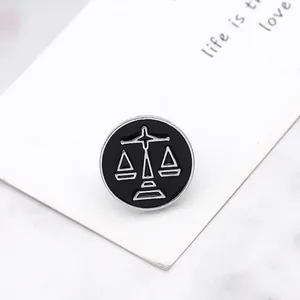 Creative Libra zodiac enamel pin badge featuring a silver scale design on a black base