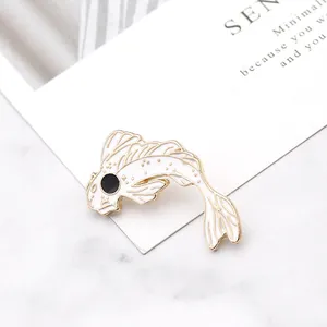 Elegant white enamel koi fish brooch with gold metal plating on a minimalist background