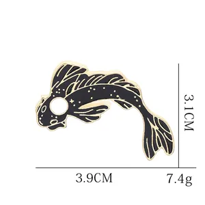Artistic black and gold enamel fish brooch with size dimensions and star patterns