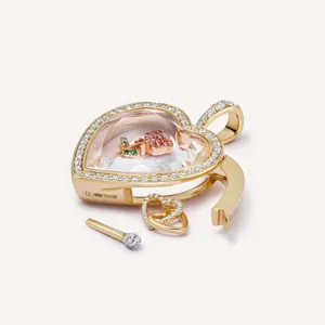 Macro shot of 18K gold heart locket featuring a rose inside with diamond borders