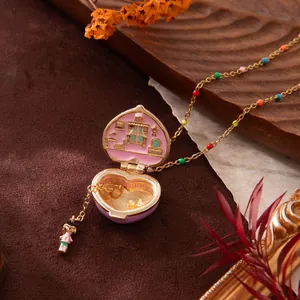 Detailed view of the cute pink heart locket opening to reveal a mini dollhouse interior.