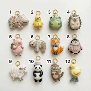 Macro detail of twelve ceramic animal charms with colorful hand-painted glaze and gold rings