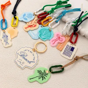 Colorful resin charms set with palm tree, shell, and lobster motifs for bags