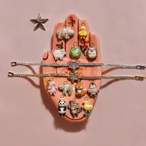 Cute animal enamel charms and star bracelets collection on a pink jewelry tray