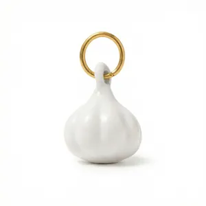 Dettaglio macro del ciondolo ad aglio in ceramica con anello placcato oro 18 carati