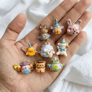 Handheld view of nine colorful cute animal charms in stainless steel with a glossy finish