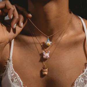 Three-layered gold necklaces with cute koala rabbit and lion animal pendants on a model