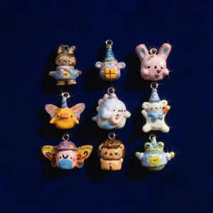 Handmade animal charms including rabbits and ducks on navy velvet background with gold loops
