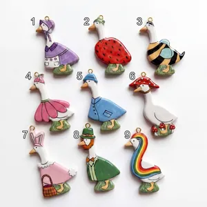 Set of 9 cute cartoon goose charms in various colorful outfits with 18K gold hangers