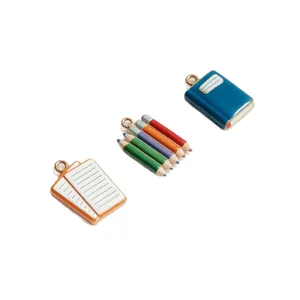 DIY stationery charm set with notebook pencil and book pendants for jewelry making