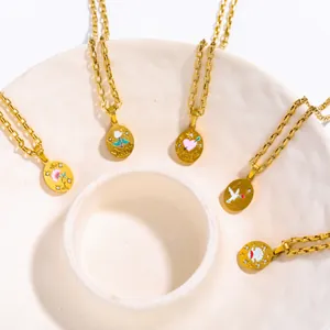 Detail of 18K gold plated paperclip chain necklaces with enamel flower and heart pendants