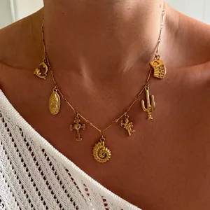 Detail of gold charms necklace featuring starfishes and poker cards on a model