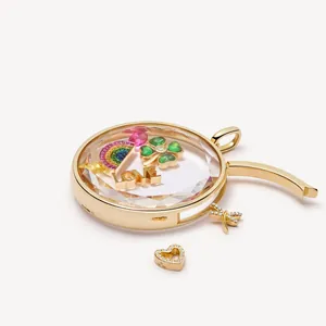 Retro 18K gold floating glass locket pendant with colorful charms on white background