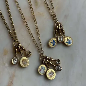 Macro view of detailed tarot charms featuring rabbit and lion painted enamel designs