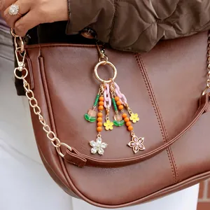 DIY keychain charm with 18K gold lobster clasp, colorful beads, and crystal floral pendants