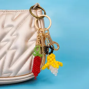 Handgefertigte Perlenanhänger Banane und Chili an einer gesteppten Handtasche