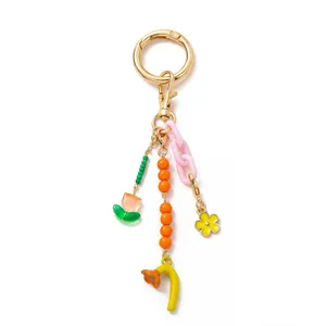 Detailed shot of a colorful 18K gold plated keychain with tulip and floral charms