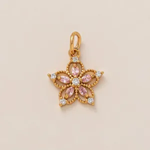 Detail of pink crystal flower pendant with 18K gold plating and diamond accents