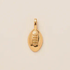 Close-up of 18K gold plated American football pendant with detailed stitching texture