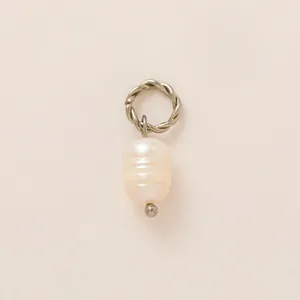 Macro detail of a baroque freshwater pearl pendant with a silver twisted rope ring hook