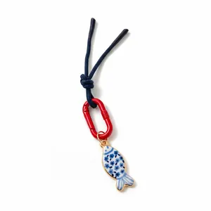 Blue braided rope keychain with red carabiner and blue-white floral fish charm