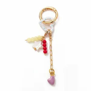 Close-up of DIY keychain with gold metal clasp and colorful heart and star beads