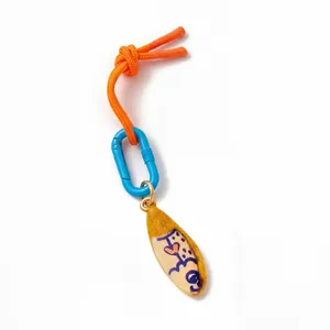 Detail of the bright orange woven cord with blue D-ring and colorful painted heart charm