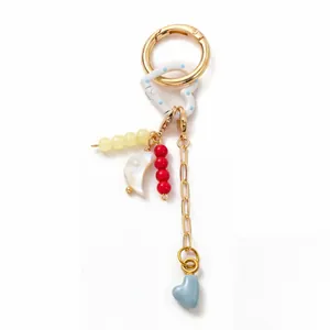 Detail of 18K gold-plated keychain with moon pendant, colorful beads and heart charms