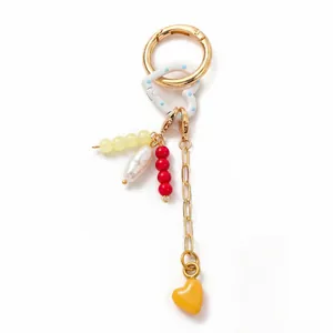 Detail of 18K gold-plated keychain with colorful resin beads and pearl heart charms