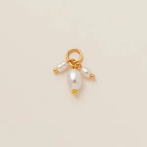 Detailed view of three white oval pearls on a 18K gold plated ring for DIY bag charms