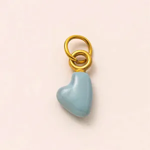 Detail view of a sky blue heart pendant with 18K gold-plated rings for DIY jewelry