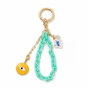 Chic keychain with mint acrylic chain, evil eye pendant and white flower charm in gold