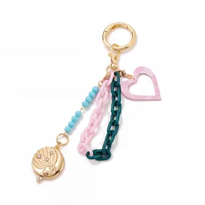 Detail of colorful charm keychain featuring star-moon pendant and heart shape ornaments