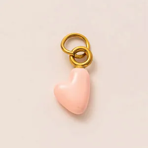 Detailed view of pink heart pendant with gold-plated ring for DIY jewelry making