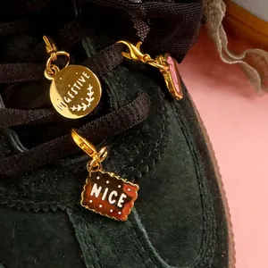 Biscuit themed metal shoe charms featuring Digestive and Nice charms on black sneakers