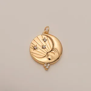 Detailed close-up of gold moon and star pendant with embedded crystals and metallic luster