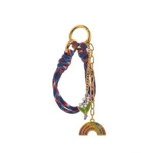 Braided rope keychain with crystal rainbow pendant and lily of the valley enamel charm