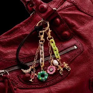 DIY 18K gold plated bag pendant with pearls and colorful charms on a red leather bag