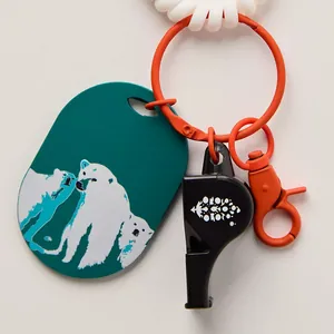 Vibrant fish-shaped whistle bag charm with orange ring and polar bear resin tag