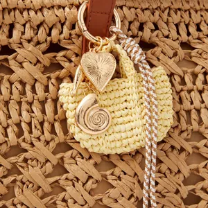 Vintage heart lock and key bag charm with woven straw accents and golden pendants