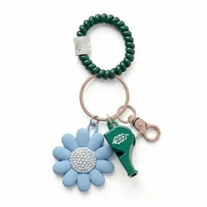Detail of teal phone cord wristband with blue sunflower charm and whistle keychain accessory