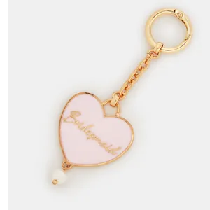 Detail of pink heart-shaped Bridesmaid charm with gold lettering and white pearl drop