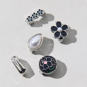 Detail of blue floral enamel charms and pearl shoe clips for flip flops and sandals