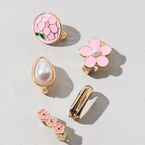Detail of five-piece set blue flower and pearl charms for sandals with gold finish