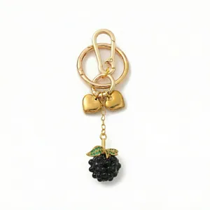 Detailed view of luxury blackberry keychain with green crystals and gold heart charms