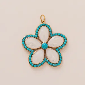 Golden five-petal flower pendant with white enamel petals and turquoise bead accents