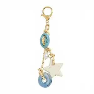 Marine style bag charm with ceramic beads, star pendant and golden lobster clasp