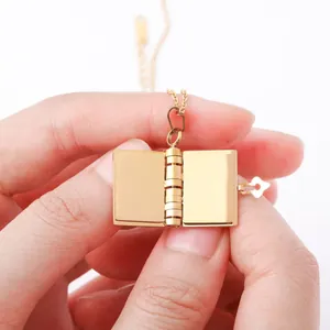 Macro shot of an openable gold book locket necklace with delicate hinge and inner space